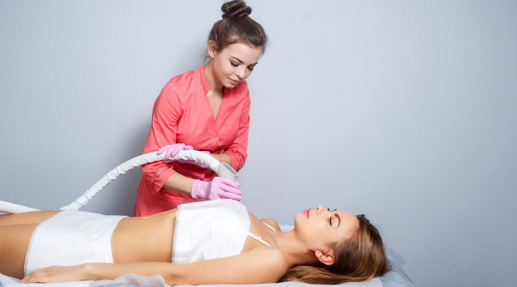 woman laying peacefully while aesthetician performs CoolSculpting procedure